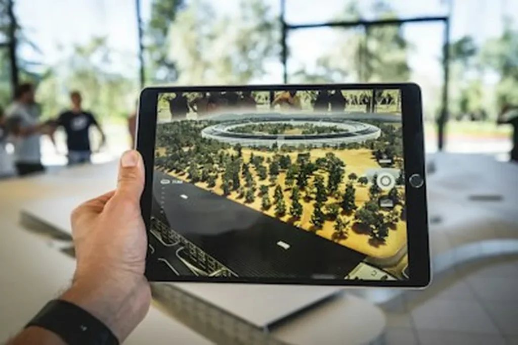 hand holding tablet augmented reality aerial view circular building trees